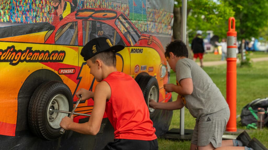 A pair of patrollers race to see who can change a tire the fastest.